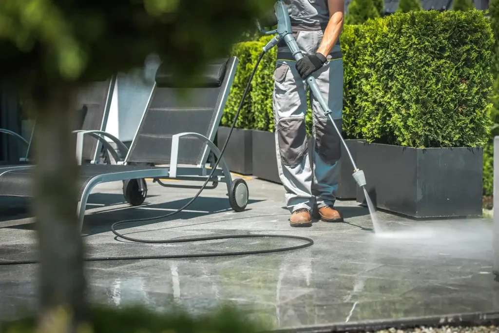 Cleaning a concrete patio with a pressure washer
