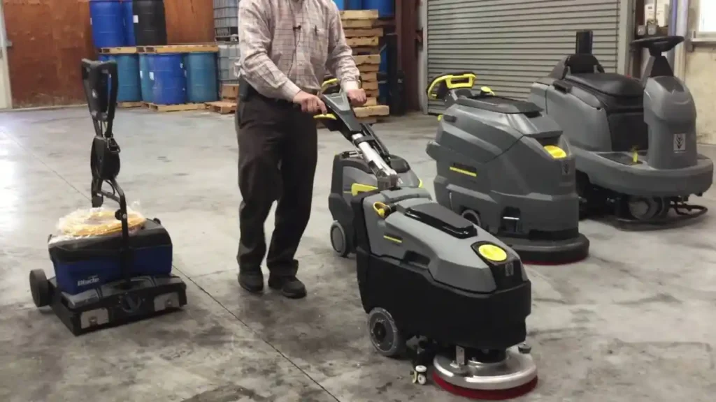 Ride-on and walk-behind floor scrubbers side by side