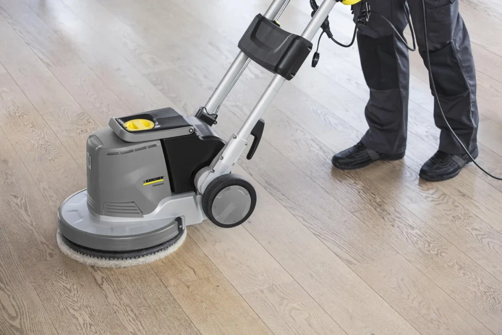 Operator using floor cleaning machine with proper safety gear