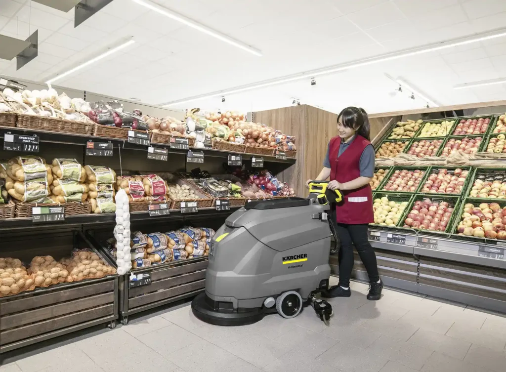 A women with floor cleaning machines in store to clean floor