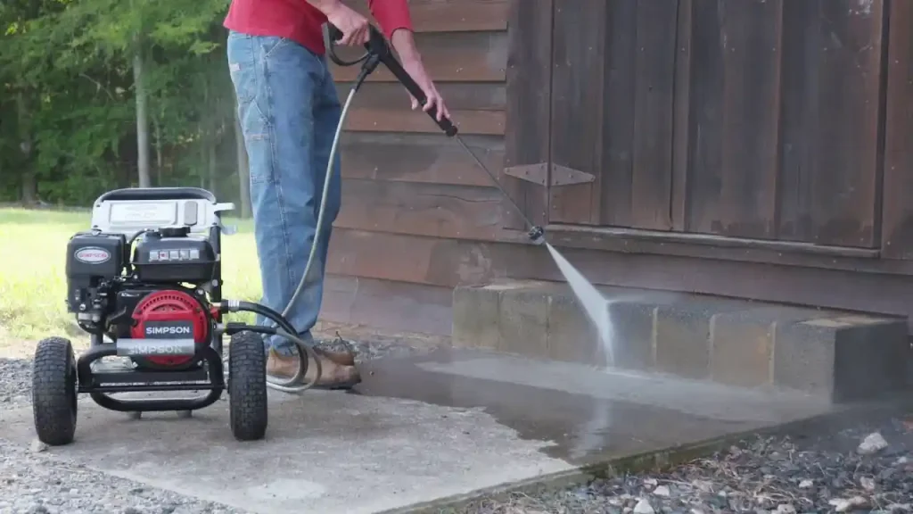 Simpson pressure washer is being using to clean concrete